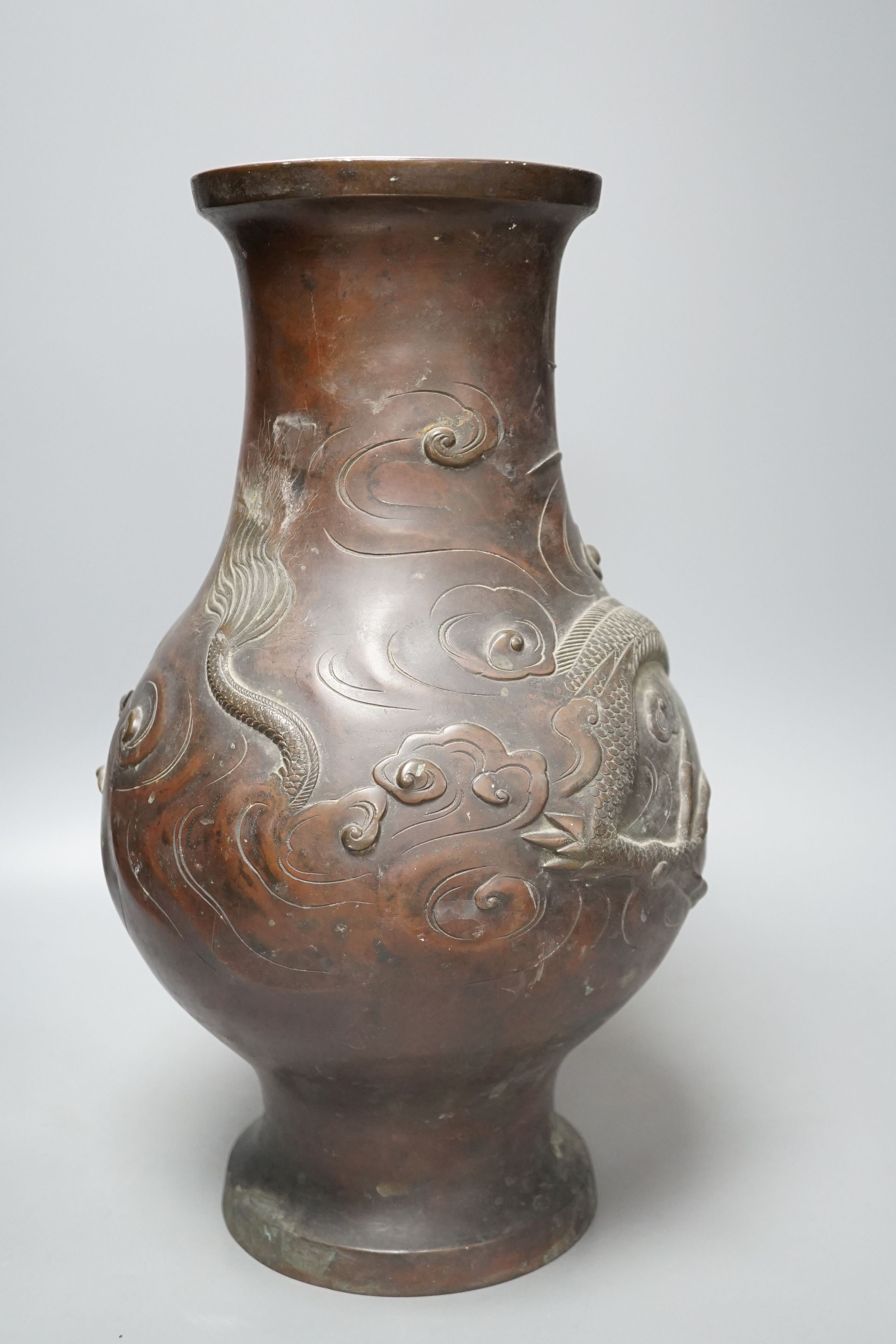 A large 19th century Japanese bronze dragon designed vase, 40cms high.